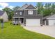 Stylish two-story home featuring a spacious two-car garage, complemented by a lush green lawn at 852 Cokesbury Park Lane Ln, Fuquay Varina, NC 27526