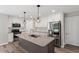 Kitchen with granite counters, white cabinets, stainless steel appliances, and decorative hanging lights at 852 Cokesbury Park Lane Ln, Fuquay Varina, NC 27526
