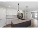 Kitchen with granite counters, a large island, stainless steel appliances, and ample storage at 852 Cokesbury Park Lane Ln, Fuquay Varina, NC 27526