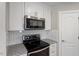 Close up of modern kitchen with granite countertops, stainless steel appliances, and subway tile backsplash at 852 Cokesbury Park Lane Ln, Fuquay Varina, NC 27526