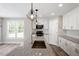 Modern kitchen with granite counters, white cabinets, and sleek stainless steel appliances at 852 Cokesbury Park Lane Ln, Fuquay Varina, NC 27526
