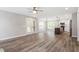 Bright, open-concept living room featuring wood floors, and double doors to the backyard at 852 Cokesbury Park Lane Ln, Fuquay Varina, NC 27526