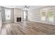 Spacious living room with modern vinyl plank flooring, a cozy fireplace, and bright natural light at 852 Cokesbury Park Lane Ln, Fuquay Varina, NC 27526