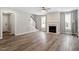 Spacious living room with a fireplace, gray walls, and modern vinyl flooring at 852 Cokesbury Park Lane Ln, Fuquay Varina, NC 27526