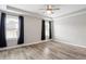 Spacious main bedroom featuring a tray ceiling, ceiling fan, and bright windows at 852 Cokesbury Park Lane Ln, Fuquay Varina, NC 27526