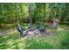 Fire pit area with Adirondack chairs, providing a cozy gathering spot amidst lush trees at 8840 Woodyhill Rd, Raleigh, NC 27613