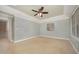 Spacious bedroom features a tray ceiling with fan and neutral carpeting at 8840 Woodyhill Rd, Raleigh, NC 27613