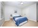 Bright bedroom featuring two windows and light colored walls, ceiling fan, and carpeted floors at 8840 Woodyhill Rd, Raleigh, NC 27613