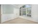 Bedroom with vaulted ceiling, large window overlooking backyard, and neutral carpet at 8840 Woodyhill Rd, Raleigh, NC 27613