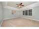Large bedroom shows neutral paint, plush carpet, and big windows at 8840 Woodyhill Rd, Raleigh, NC 27613