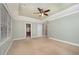 Bright bedroom offers natural light, neutral carpet, and doorway to bathroom at 8840 Woodyhill Rd, Raleigh, NC 27613