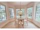 Cozy dining nook with large windows offering scenic backyard views at 8840 Woodyhill Rd, Raleigh, NC 27613