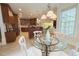Bright eat-in kitchen with glass top table and decorative chandelier at 8840 Woodyhill Rd, Raleigh, NC 27613