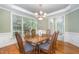 Elegant dining room features hardwood floors, wainscoting, and a stylish chandelier at 8840 Woodyhill Rd, Raleigh, NC 27613