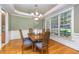 Elegant dining room features hardwood floors, wainscoting, and a stylish chandelier at 8840 Woodyhill Rd, Raleigh, NC 27613
