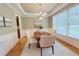 Elegant dining room with a chandelier and ample natural light at 8840 Woodyhill Rd, Raleigh, NC 27613