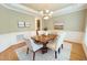Charming dining area featuring wainscoting and a stylish chandelier at 8840 Woodyhill Rd, Raleigh, NC 27613