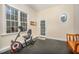 This exercise room has a window, a door leading outside, an oval window, and an exercise bike at 8840 Woodyhill Rd, Raleigh, NC 27613