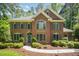 Beautiful brick home featuring classic architecture and meticulous landscaping at 8840 Woodyhill Rd, Raleigh, NC 27613
