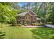 Charming two-story brick home with a manicured lawn and lush landscaping at 8840 Woodyhill Rd, Raleigh, NC 27613