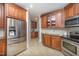 Modern kitchen with stainless steel refrigerator and dark wood cabinets at 8840 Woodyhill Rd, Raleigh, NC 27613