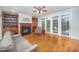 Comfortable living room with a fireplace, built-in shelves, hardwood floors, and natural light at 8840 Woodyhill Rd, Raleigh, NC 27613