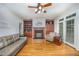 Charming living room showcasing a fireplace, built-in shelves, hardwood floors, and ample seating at 8840 Woodyhill Rd, Raleigh, NC 27613