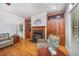 Living room featuring a fireplace, built-in shelves, hardwood floors, and lots of natural light at 8840 Woodyhill Rd, Raleigh, NC 27613