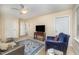 Cozy living room featuring neutral walls, ceiling fan, area rug and comfortable seating at 8840 Woodyhill Rd, Raleigh, NC 27613
