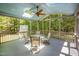 Covered screened porch featuring a ceiling fan, skylights and outdoor seating, perfect for enjoying nature at 8840 Woodyhill Rd, Raleigh, NC 27613