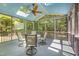 Covered screened porch featuring a ceiling fan, skylights and outdoor seating, perfect for enjoying nature at 8840 Woodyhill Rd, Raleigh, NC 27613
