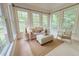 Inviting sunroom filled with natural light, seating area, and multiple large windows at 8840 Woodyhill Rd, Raleigh, NC 27613