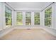 Sunroom with carpet, multiple windows and a view of the backyard at 8840 Woodyhill Rd, Raleigh, NC 27613
