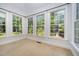 Sunroom with carpet, multiple windows and a view of the backyard at 8840 Woodyhill Rd, Raleigh, NC 27613