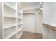 An organized walk-in closet with white shelving and a hanging rod at 8840 Woodyhill Rd, Raleigh, NC 27613