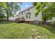 Home's backyard and deck with a lawn, surrounded by a wood fence at 9212 Sayornis Ct, Raleigh, NC 27615