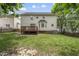 View of home's backyard, deck, and bay window from the lawn at 9212 Sayornis Ct, Raleigh, NC 27615