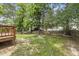 Backyard featuring a wooden deck, fire pit, and mature shade trees at 9212 Sayornis Ct, Raleigh, NC 27615