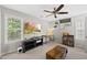 Relaxing bedroom with large windows, a ceiling fan, and a workstation at 9212 Sayornis Ct, Raleigh, NC 27615