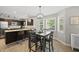 Bright dining area featuring wood floors, large windows, and a modern light fixture at 9212 Sayornis Ct, Raleigh, NC 27615