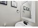 Neat half bathroom featuring a white sink, updated fixtures, and neutral paint at 9212 Sayornis Ct, Raleigh, NC 27615