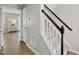 Hallway features carpeted stairs, a view to the living room, and a white interior door at 9212 Sayornis Ct, Raleigh, NC 27615