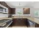 Updated kitchen with stainless appliances, granite counters, and ample cabinet space at 9212 Sayornis Ct, Raleigh, NC 27615