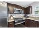 Well-equipped kitchen with stainless appliances, granite counters, and subway tile backsplash at 9212 Sayornis Ct, Raleigh, NC 27615