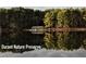 Picturesque lake view of Durant Nature Preserve showcasing natural beauty and a serene setting at 9212 Sayornis Ct, Raleigh, NC 27615