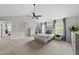 Airy primary bedroom features a ceiling fan, neutral walls, and carpeted floor, creating a serene and inviting atmosphere at 9212 Sayornis Ct, Raleigh, NC 27615