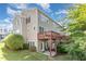 Exterior of home showcasing the back deck, backyard, and lush landscaping at 100 Stratford Lakes # 130, Durham, NC 27713