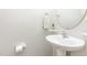 Clean and simple half bath features a pedestal sink, and neutral walls at 100 Stratford Lakes # 130, Durham, NC 27713