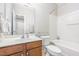 Full bathroom features a vanity with storage, a toilet, and a shower-tub combination at 100 Stratford Lakes # 130, Durham, NC 27713
