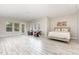 Spacious, well-lit bedroom features tile floors and a door leading to the backyard at 100 Stratford Lakes # 130, Durham, NC 27713